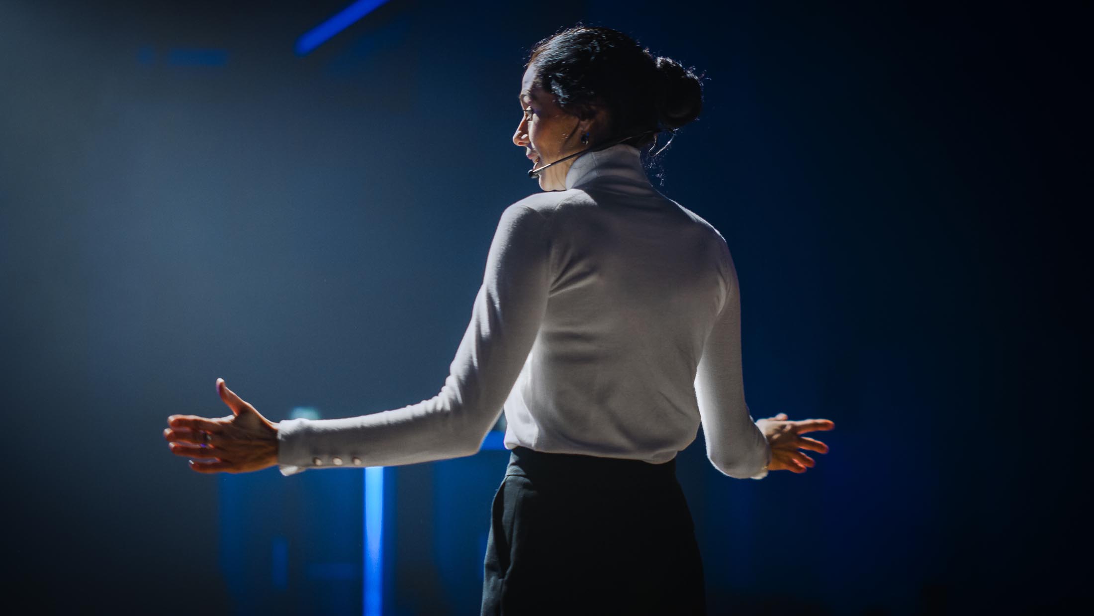 Female Motivational Speaker on Stage, Talking about Happiness, Diversity, Success, Leadership, STEM and How to Be Productive. Woman Presenter Leads Tech Business Conference.